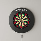 Target Notched Surround in black mounted on a wall with a dartboard
