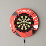 Target Patterned Notched Surround in red patterned mounted on a wall with a dartboard