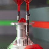 Angled close-up of limited edition tungsten darts with red flights in a display stand, showing barrel grip detail and Darth Vader laser-etched engraving