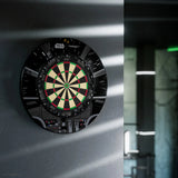 Mounted Star Wars Millennium Falcon dartboard bundle with themed surround in modern game room setting