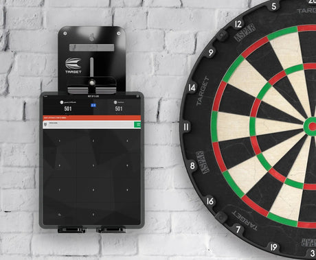 Wall-mounted tablet holder in use displaying dart scoring app beside dartboard, polycarbonate bracket and scoreboard visible, ideal for darts setup