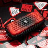 Red and black Stephen Bunting darts case angled on warning sign backdrop, showcasing textured hard shell and zipper for dart storage.
