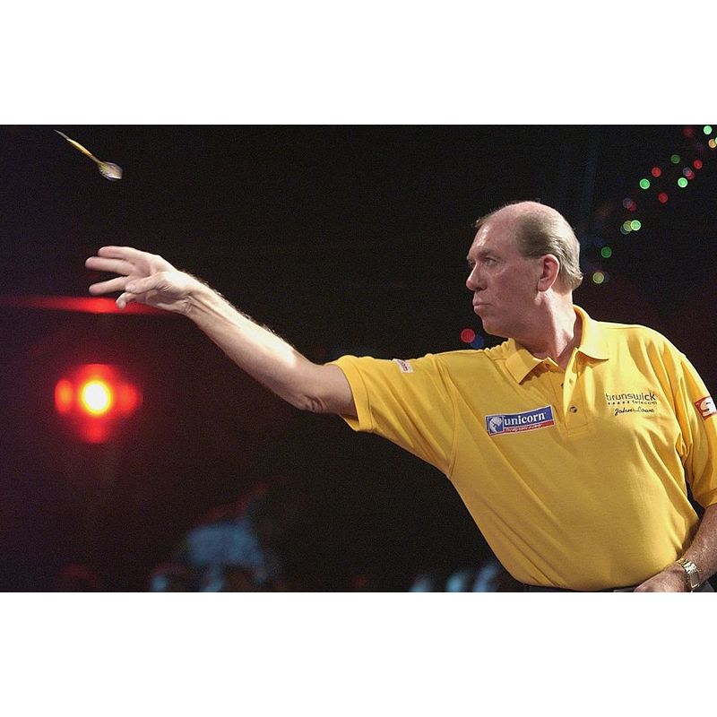 Dart throwing action shot, mid-throw, highlighting player grip and tungsten dart in use for competitive darts gameplay