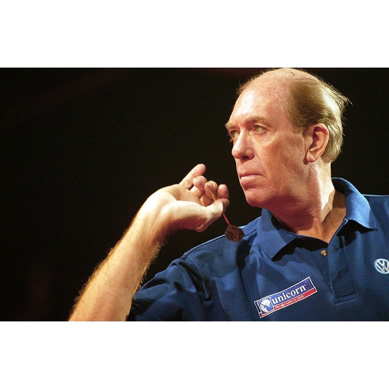 Darts player in action holding 90 percent tungsten dart, close-up lifestyle shot highlighting grip technique and throwing form