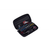 Open darts case on white background with organized flights, shafts, and multicolor spare tips arranged for easy access