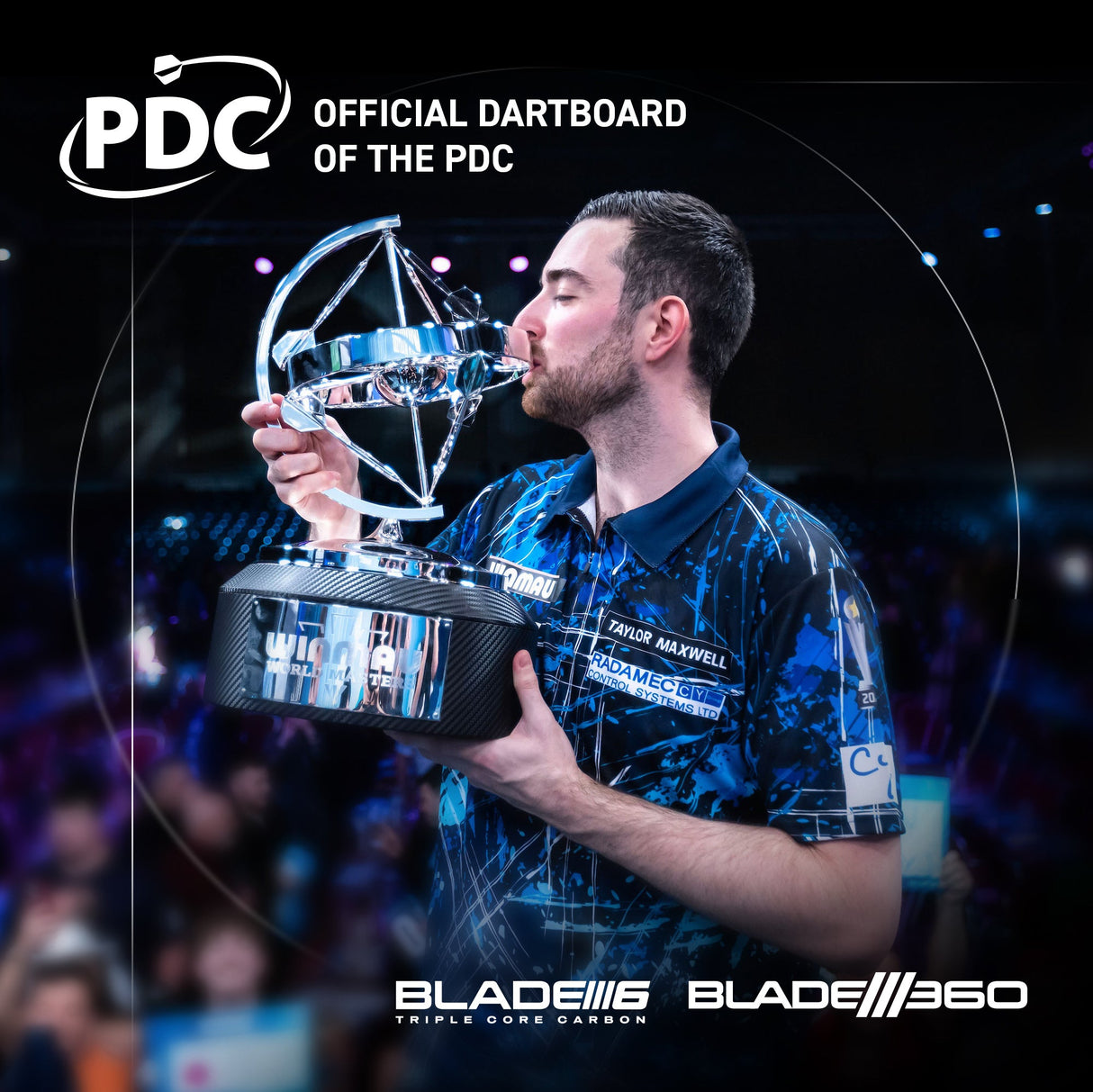 Darts champion celebrating with trophy on stage, event lighting and Blade 360 dartboard branding visible