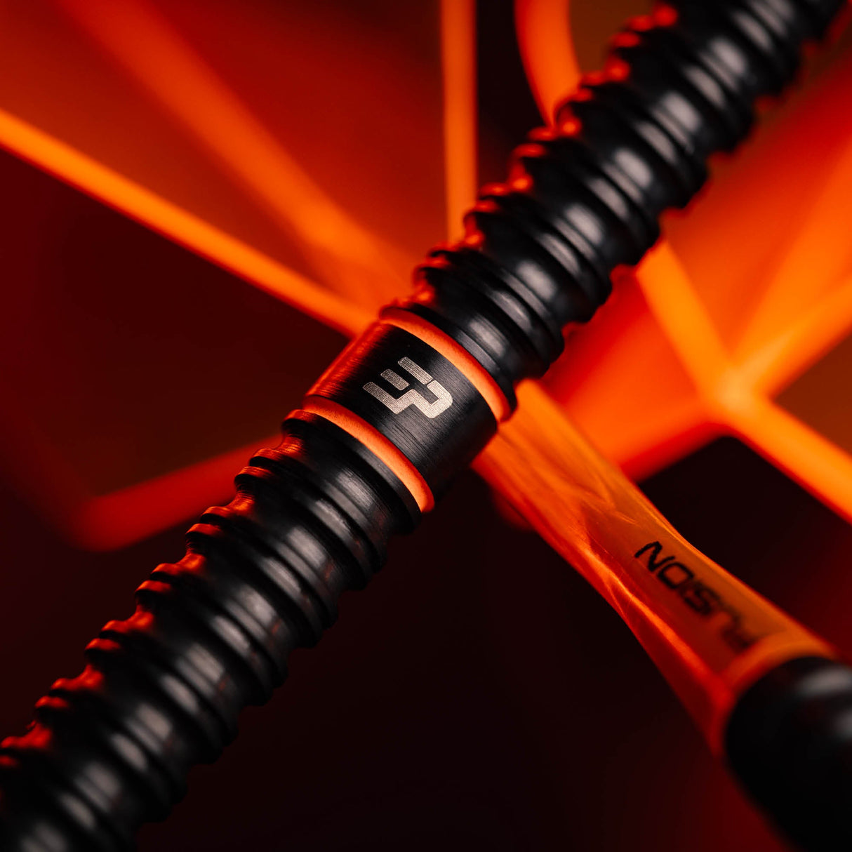 Close up of the black ring grip barrel with orange accent on the Emma Paton Edit