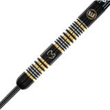 Close-up of Winmau MVG Trilogy dart barrel showing 90% tungsten, ring grip texture, black and gold accents, engraved logo