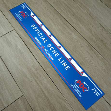 Angled view of official oche line throwline mat for darts setup, showing clear distance markings and scale on wooden floor.